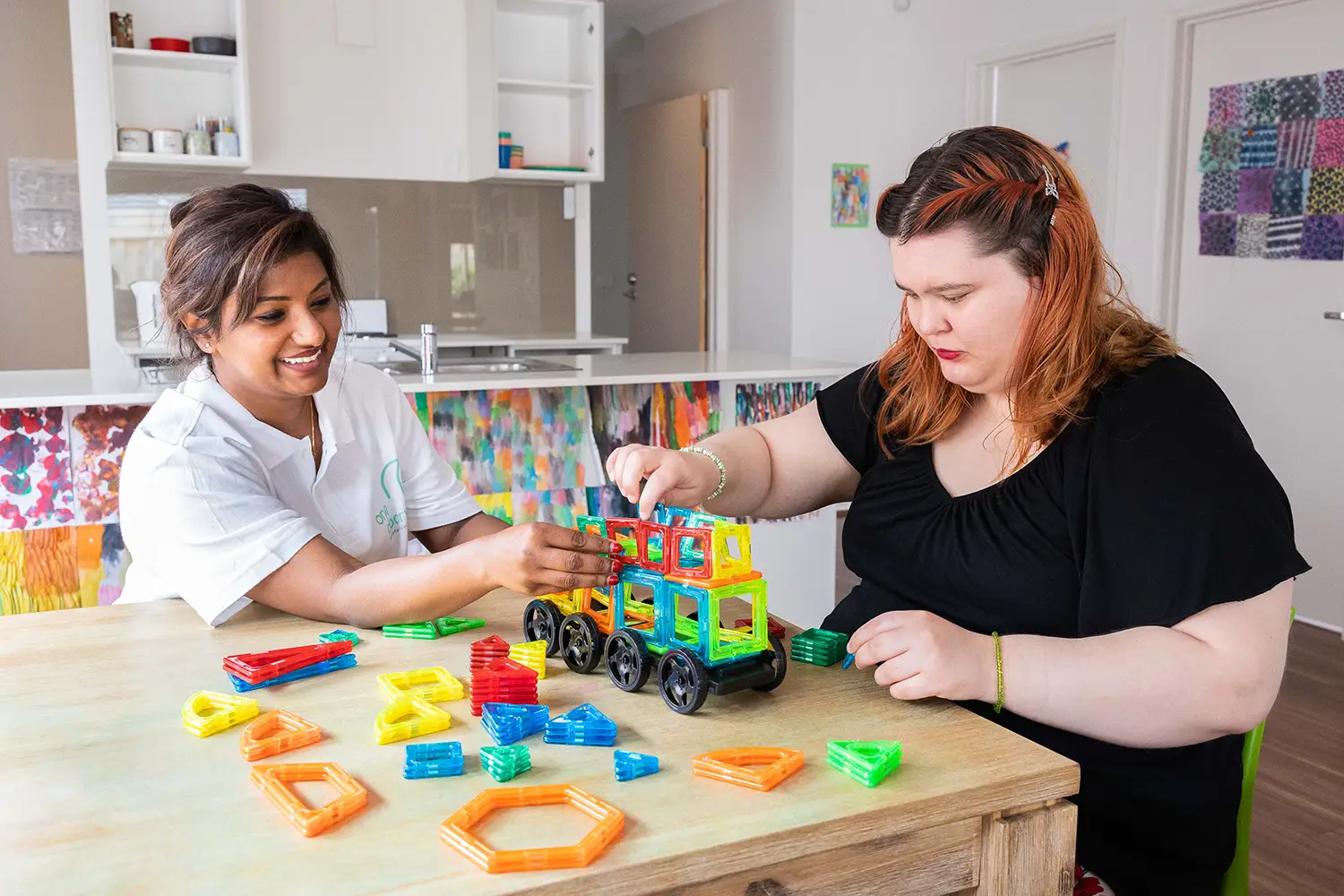 Support worker playing with building blocks